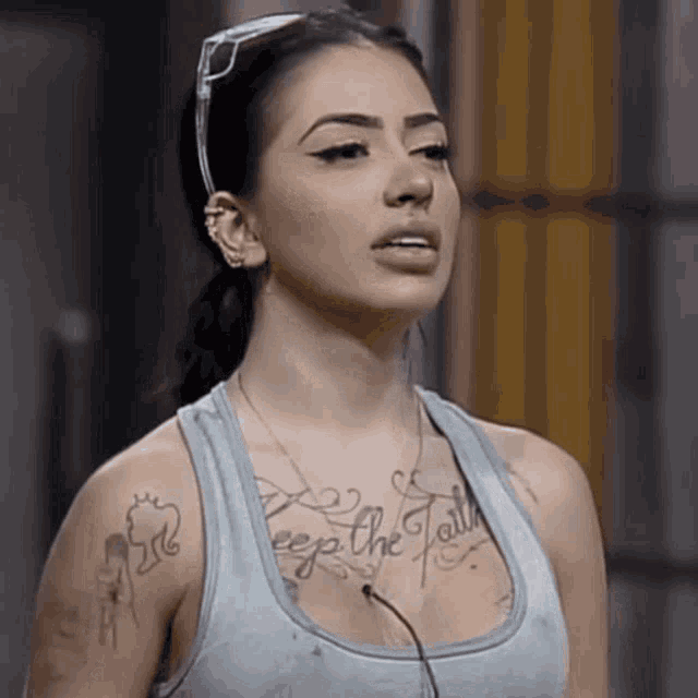 a woman with a tattoo that says keep the faith