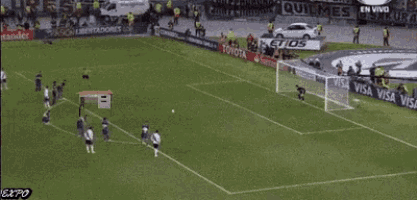 a soccer game is being played on a field with toyota and santander banners