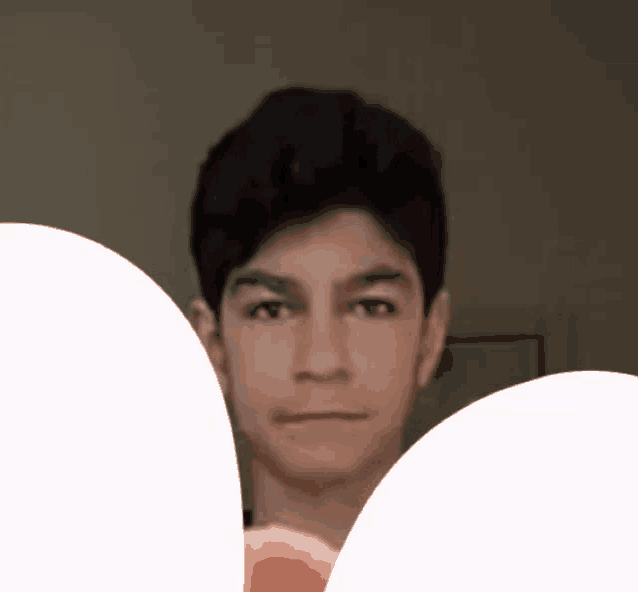 a close up of a young man 's face with a white border around it