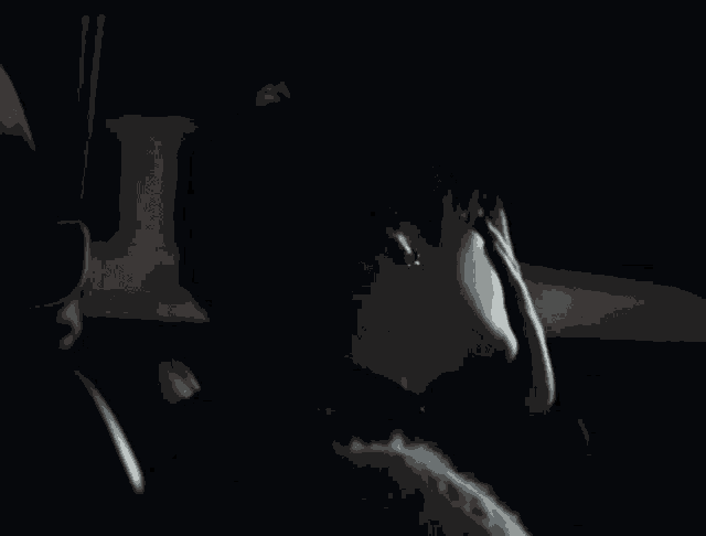 a person sitting in a car with their hand on their head