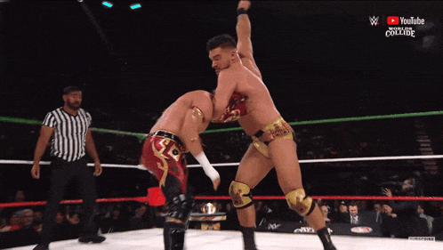 two men are wrestling in a ring with a youtube logo on the bottom