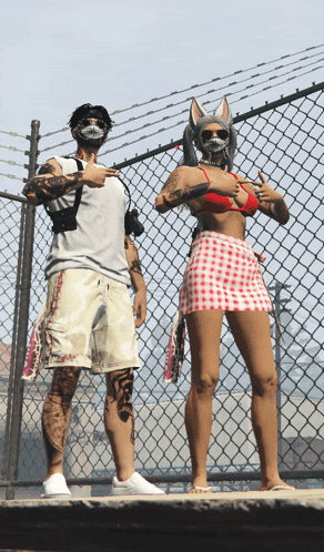 a man and a woman standing next to each other in front of a fence