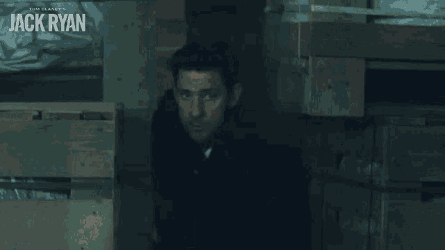 a man is holding a gun with the name jack ryan on the bottom