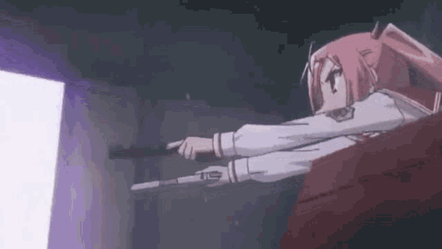 a girl is holding a gun in her hand and pointing it at something .