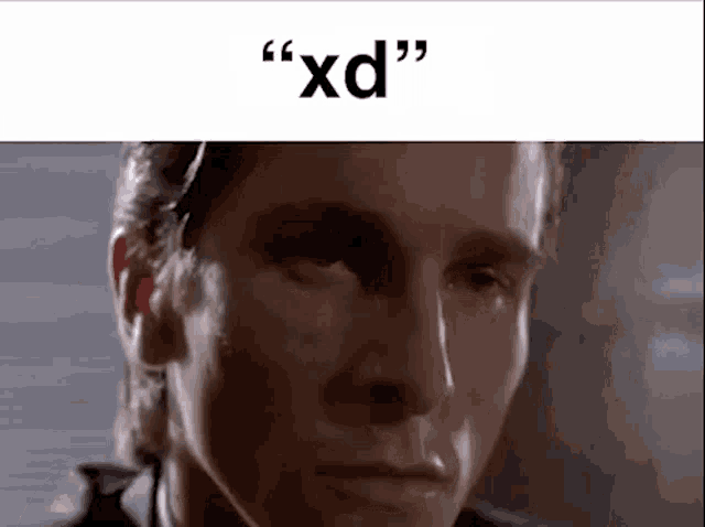 a close up of a man 's face with the words `` xd '' written above him .