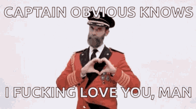 a man in a red uniform is making a heart shape with his hands .