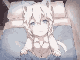 a girl with cat ears is laying on a bed