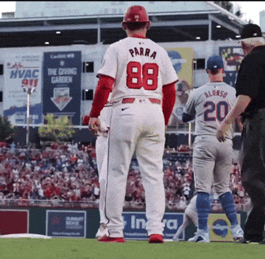 a baseball player with the number 88 on his back stands on the field