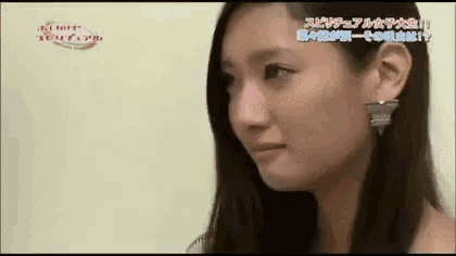 a close up of a woman 's face with japanese writing on it