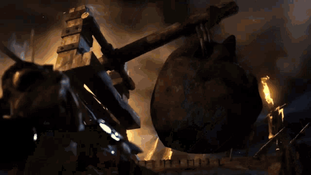 a fire is coming out of a hole in the ground in a dark cave .