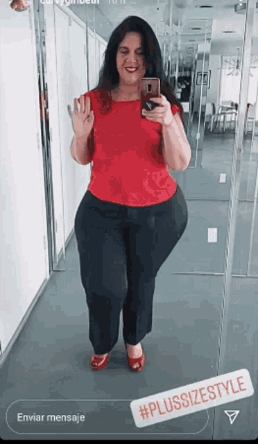 a woman taking a picture of herself in front of a mirror with the hashtag plussizestyle
