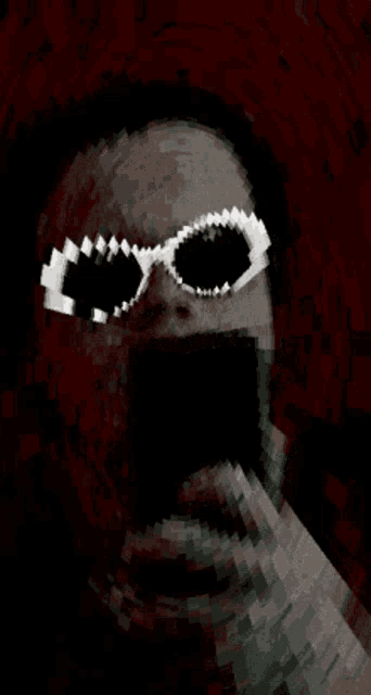 a pixelated image of a man wearing sunglasses and a mask .