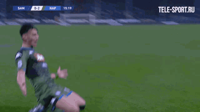 a group of soccer players are hugging each other on the field