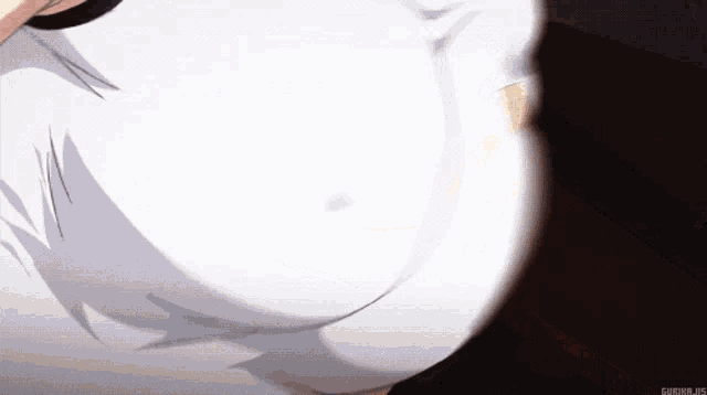 a close up of a woman 's breasts in a white top