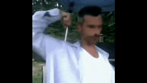 a man in a white shirt is holding a blue umbrella