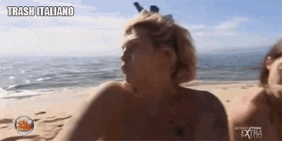 a man without a shirt is standing on a beach with the words trash italiano written above him