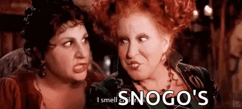 two women are standing next to each other in a room and one of them is screaming .