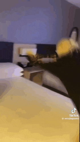 a person is sitting on a bed in a room .