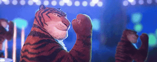 a cartoon tiger is standing on a stage with his paws up .