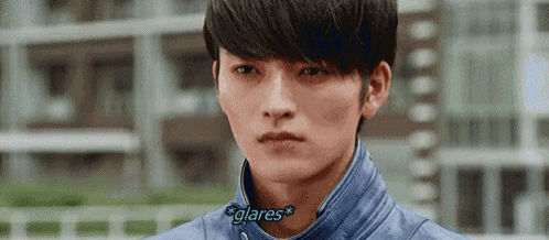 a close up of a young man 's face with the words `` glares '' written on his neck .