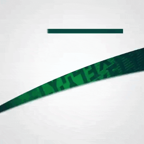 a green feather is flying in the air with a white background .