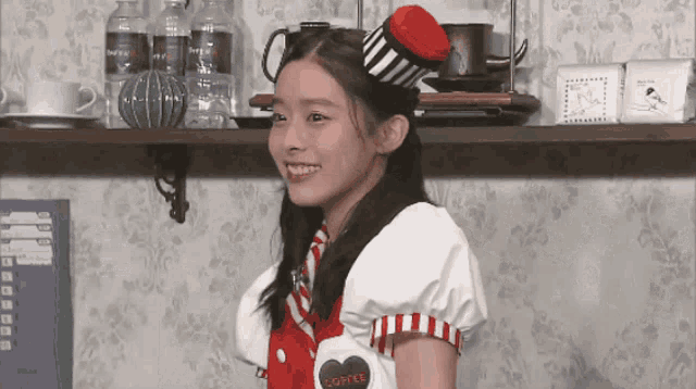a girl wearing a red and white outfit with a heart that says " coffee "