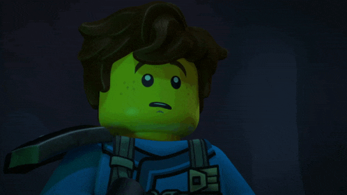 a close up of a lego character 's face with a surprised look on his face