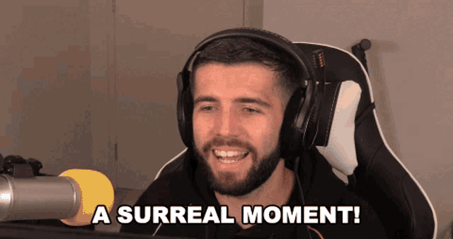 a man wearing headphones says a surreal moment in front of a microphone