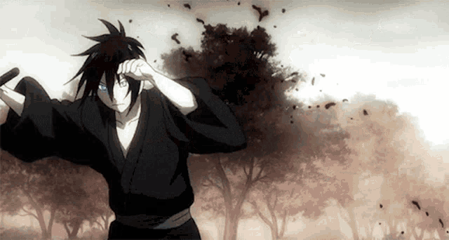 a man in a black kimono is holding a sword in front of trees