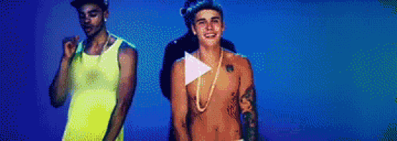 a man without a shirt is standing next to another shirtless man .