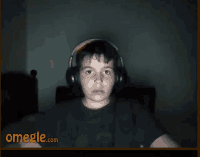 a boy wearing headphones is on a video call on omegle.com