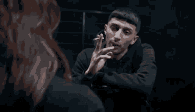 a group of people are dancing in a dark room in a video .