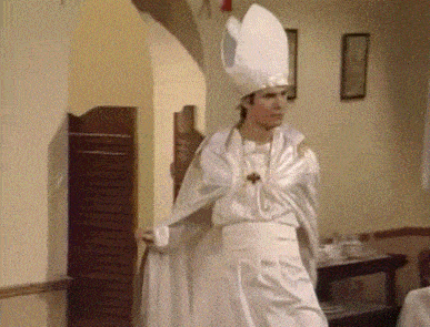 a man in a white robe and hat is standing in a room in a restaurant .