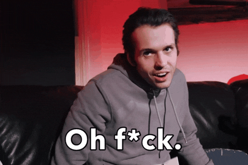a man sitting on a couch with the words oh f * ck written on his face