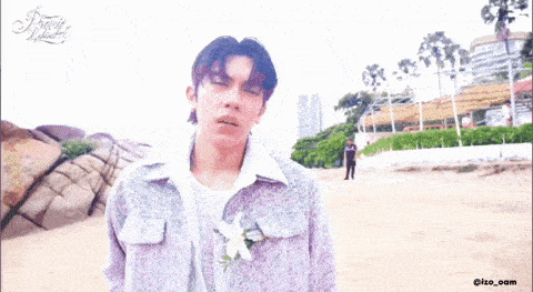 a man with a flower in his jacket is reaching out towards another man