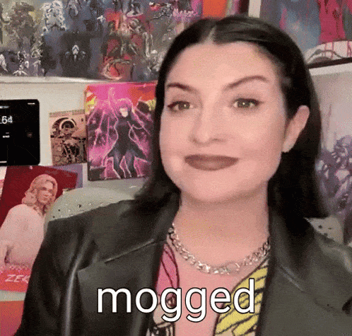 a woman wearing a black leather jacket and a chain necklace says mogged .