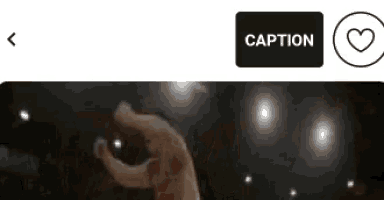 a picture of a person 's hand with a caption button next to it .