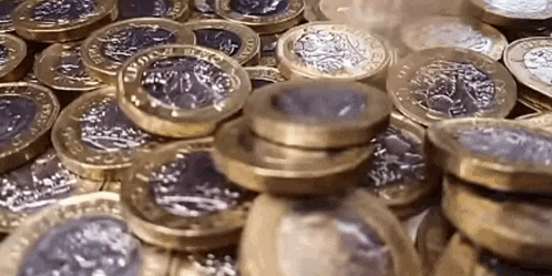 a pile of gold and silver coins stacked on top of each other .