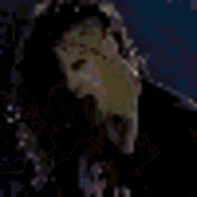 a close up of a person 's face with a microphone in a dark room .