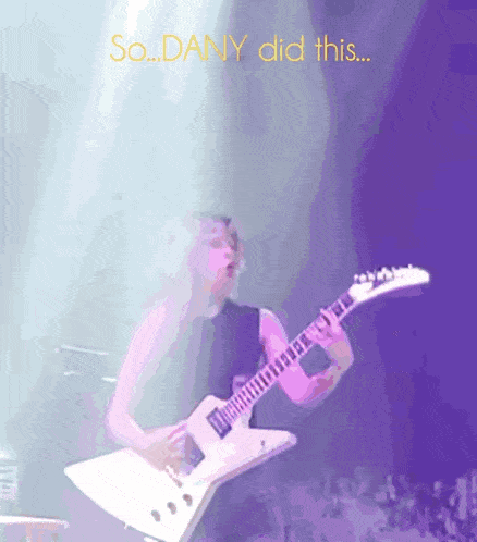 a man is playing a guitar with the words so dany did this behind him