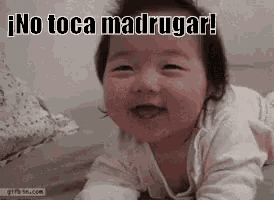 a baby is crawling on the floor and smiling with the words `` no toca madrugar '' written above it .