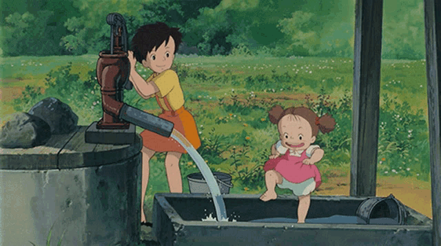 a girl pumping water into a bucket while a little girl sits in a tub