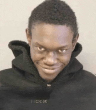a man wearing a black hoodie with the word book written on it