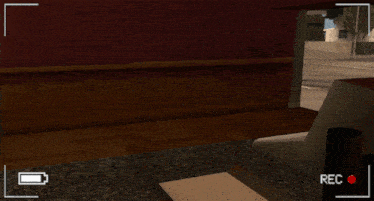 a video game screen shows a man laying on the floor and a rec button