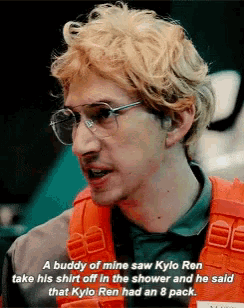 a close up of a man wearing glasses and an orange vest