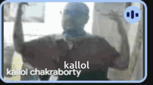 a man is standing in front of a window with his arms outstretched and the words kallol chakraborty on the bottom .
