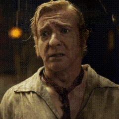a man wearing a tie and a jacket is making a funny face