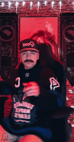 a man with a mustache wearing a hat that says 1000