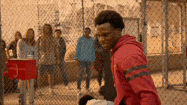 a man in a red hoodie with the letter j on it