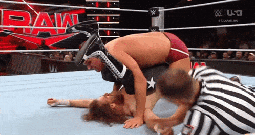 two men are wrestling in a ring with the word raw on the bottom